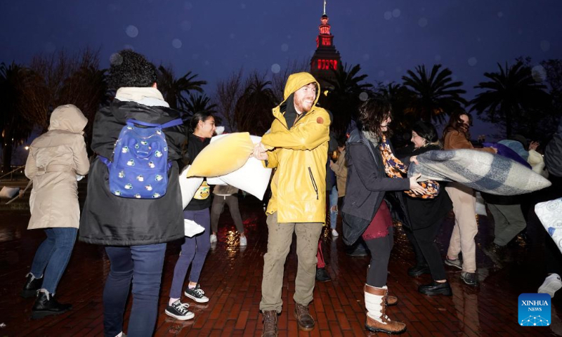 People participate in an annual pillow fight in San Francisco, the United States, Feb. 14, 2024. (Photo by Li Jianguo/Xinhua)