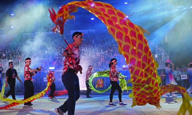 Performers perform dragon dance during the Chingay Parade as part of the Lunar New Year celebrations in Singapore's F1 Pit Building on Feb. 23, 2024. (Photo by Then Chih Wey/Xinhua)