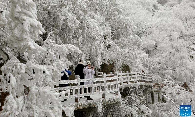 People enjoy the rime scenery at Yuntaishan Mountain upon the Sea scenic area in Lianyungang, east China's Jiangsu Province, Jan. 21, 2024. (Photo by Wang Chun/Xinhua)