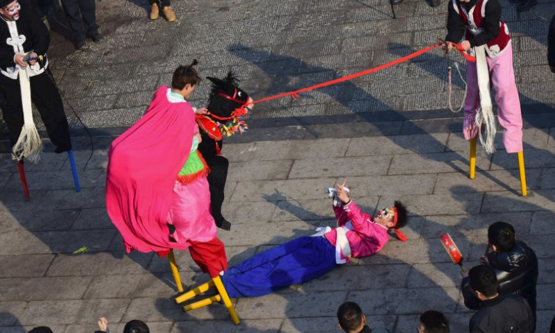 Folk artists perform a comedy show during a temple fair held in Xunxian County of central China's Henan Province, Feb. 25, 2024. Local residents of Shehuo performing teams participated in a temple fair in Xunxian on Sunday, one day after the Chinese Lantern Festival. Shehuo is a traditional carnival-like folk celebration, featuring performances like dragon dance, lion dance, traditional Chinese opera, drum playing and other folk performances that may vary in different regions. (Xinhua/Zhu Xiang)

