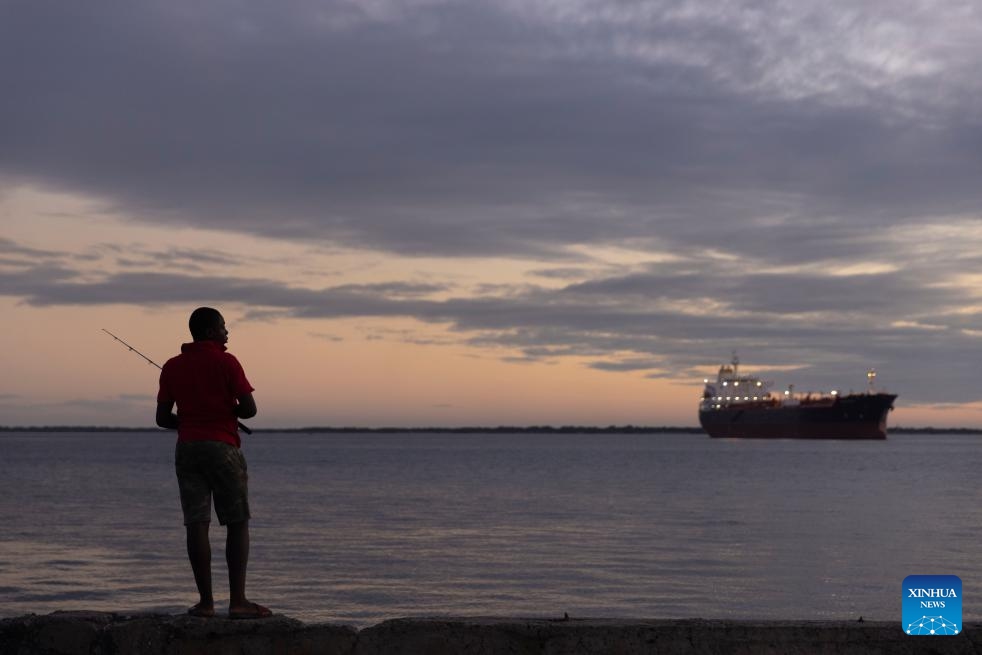 This photo taken on Jan. 18, 2024 shows a man fishing at the seaside of Kingston, Jamaica.(Photo: Xinhua)