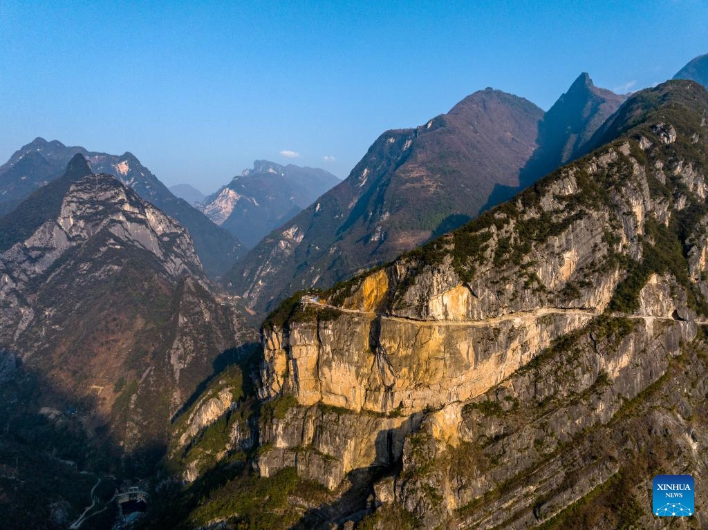 An aerial drone photo taken on Jan. 11, 2024 shows a view of Lanying Cliff Road in Wuxi County, southwest China's Chongqing. Located in Lanying Grand Canyon in Wuxi County, the Lanying Cliff Road is an awesome path carved out of the mountains. The road, built for over four years by the locals, is the only transportation route connecting Lanying Village to the outside world.(Photo: Xinhua)