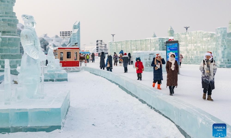 Visitors walk near ice sculptures of Terracotta Warriors in Harbin Ice and Snow World in Harbin, northeast China's Heilongjiang Province, Jan. 23, 2024. As a group of AI-generated images of ice sculptures of Terracotta Warriors went viral on the internet, artists created a series of ice sculptures of Terracotta Warriors at Harbin Ice and Snow World to attract visitors.(Photo: Xinhua)