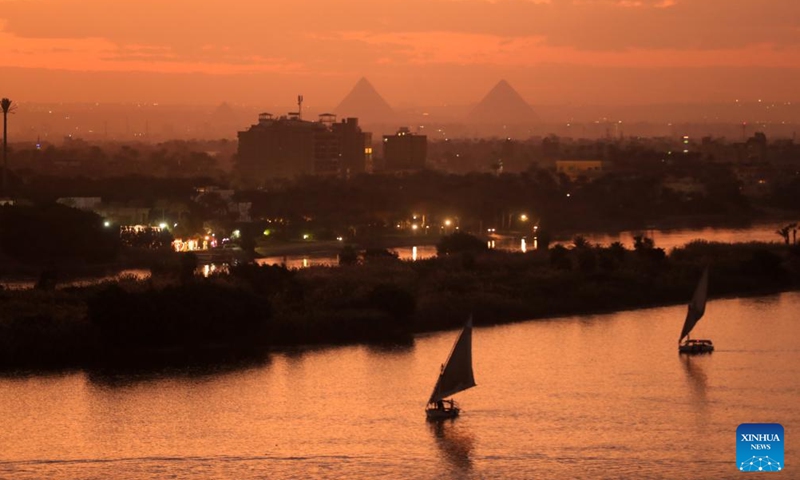 Boats sail on the Nile River with Giza Pyramids in the distance at sunset, in Cairo, Egypt, on Jan. 24, 2024.(Photo: Xinhua)