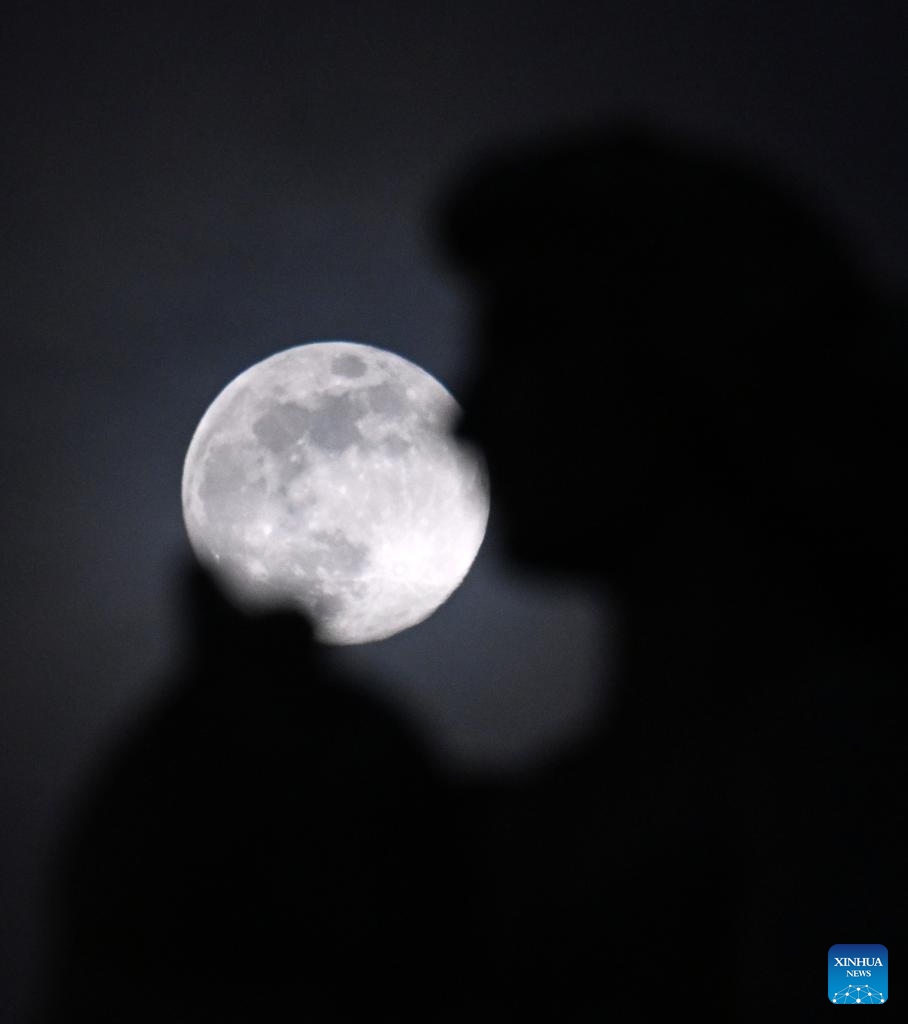 The moon is seen behind a statue in Piazza Venezia in Rome, on Jan. 24, 2024.(Photo: Xinhua)