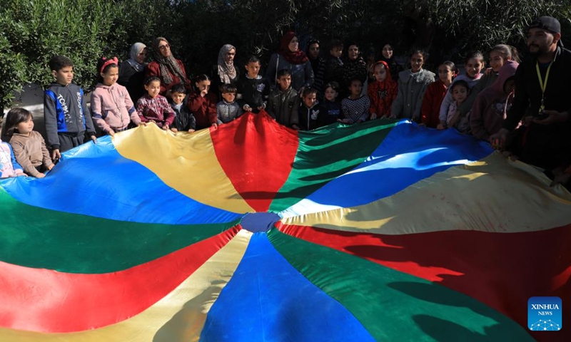 Children take part in activities organized by local volunteers at a school in the southern Gaza Strip city of Rafah, Jan. 24, 2024.(Photo: Xinhua)