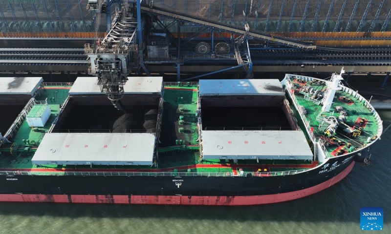 An aerial drone photo taken on Jan. 28, 2024 shows a ship loading cargo at the coal wharf of Tangshan Port in north China's Hebei Province. The province's cargo throughput reached a record high of 1.36 billion tonnes in 2023. (Xinhua/Yang Shiyao)