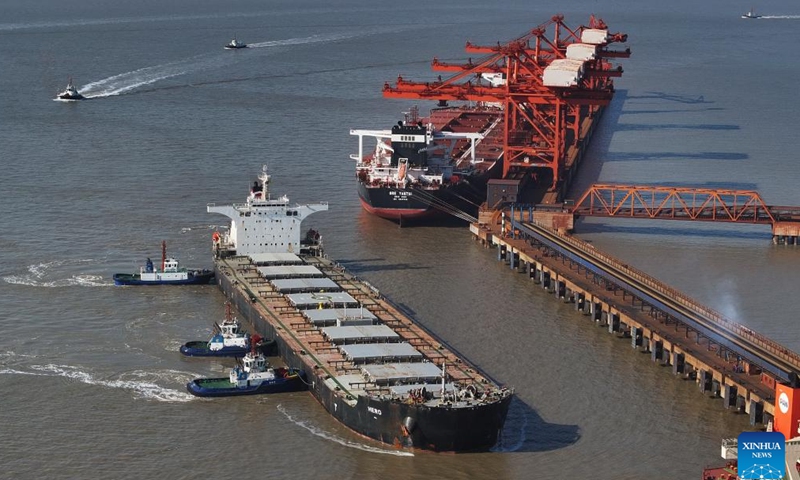 An aerial drone photo taken on Jan. 26, 2024 shows a ship sailing toward the ore wharf of the Caofeidian port area of Tangshan Port in north China's Hebei Province. The province's cargo throughput reached a record high of 1.36 billion tonnes in 2023. (Xinhua/Yang Shiyao)