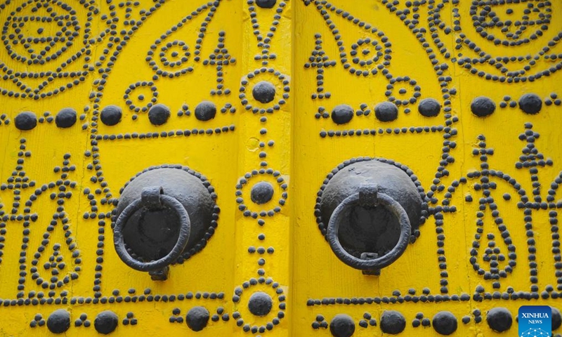 This photo taken on Jan. 28, 2024 shows a wooden door in the old city of Tunis, Tunisia. Decorating wooden doors with metal rivet patterns has been a local tradition in Tunisia.(Photo: Xinhua)