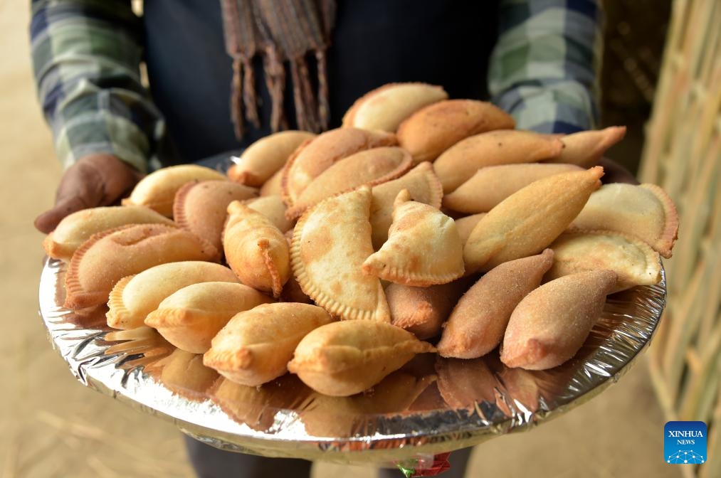 A vendor displays a type of Pitha for sale during a festival in Dhaka, Bangladesh, Jan. 31, 2024.(Photo: Xinhua)