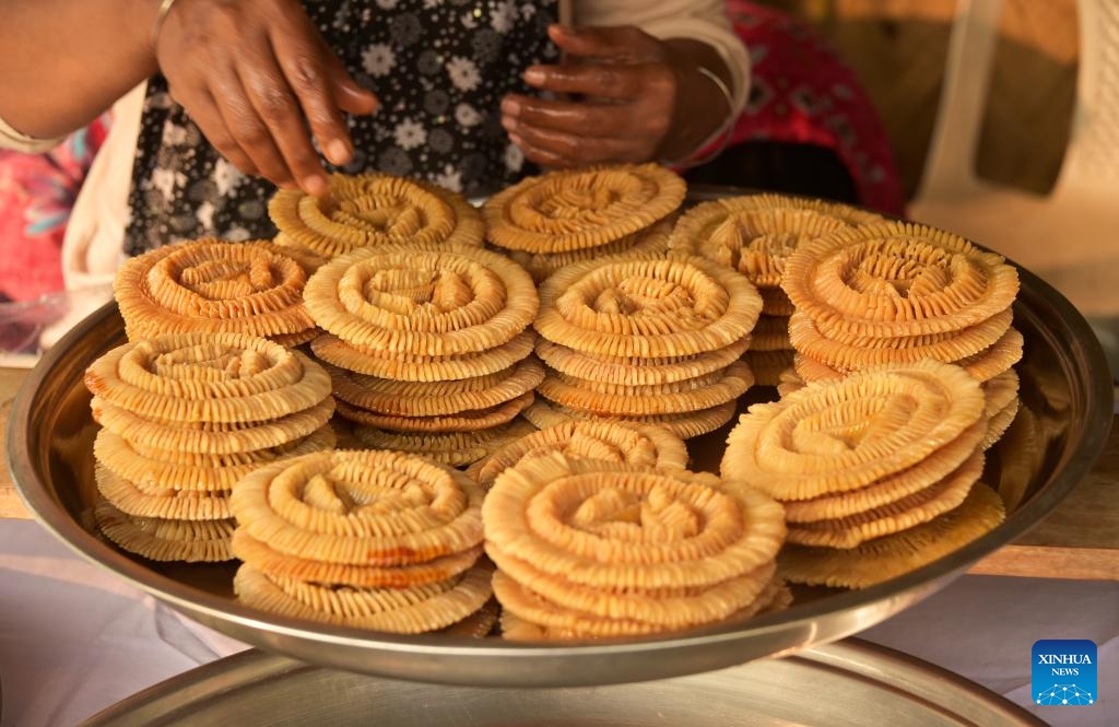 A vendor displays a type of Pitha for sale during a festival in Dhaka, Bangladesh, Jan. 31, 2024.(Photo: Xinhua)