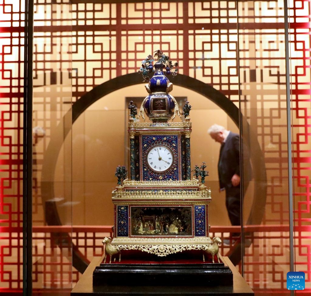 A man visits the exhibition Zimingzhong: Clockwork Treasures from China's Forbidden City, in London, Britain, Feb. 1, 2024. An exhibition opened at the Science Museum in London on Thursday, featuring 23 resplendent mechanical clocks, called zimingzhong, on loan from the Palace Museum in Beijing.(Photo: Xinhua)