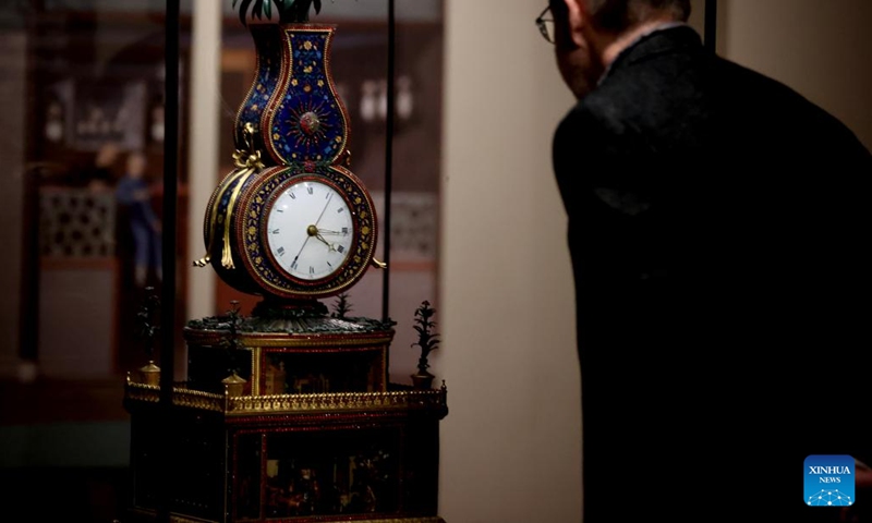 A man visits the exhibition Zimingzhong: Clockwork Treasures from China's Forbidden City, in London, Britain, Feb. 1, 2024. An exhibition opened at the Science Museum in London on Thursday, featuring 23 resplendent mechanical clocks, called zimingzhong, on loan from the Palace Museum in Beijing.(Photo: Xinhua)