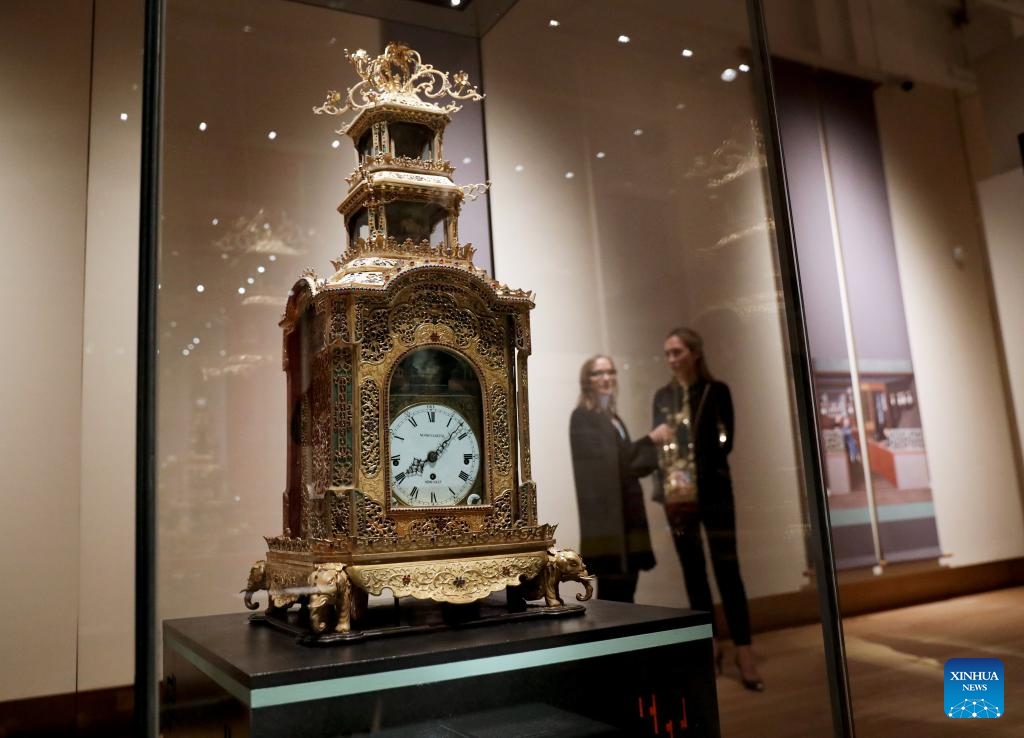 People visit the exhibition Zimingzhong: Clockwork Treasures from China's Forbidden City, in London, Britain, Feb. 1, 2024. An exhibition opened at the Science Museum in London on Thursday, featuring 23 resplendent mechanical clocks, called zimingzhong, on loan from the Palace Museum in Beijing.(Photo: Xinhua)