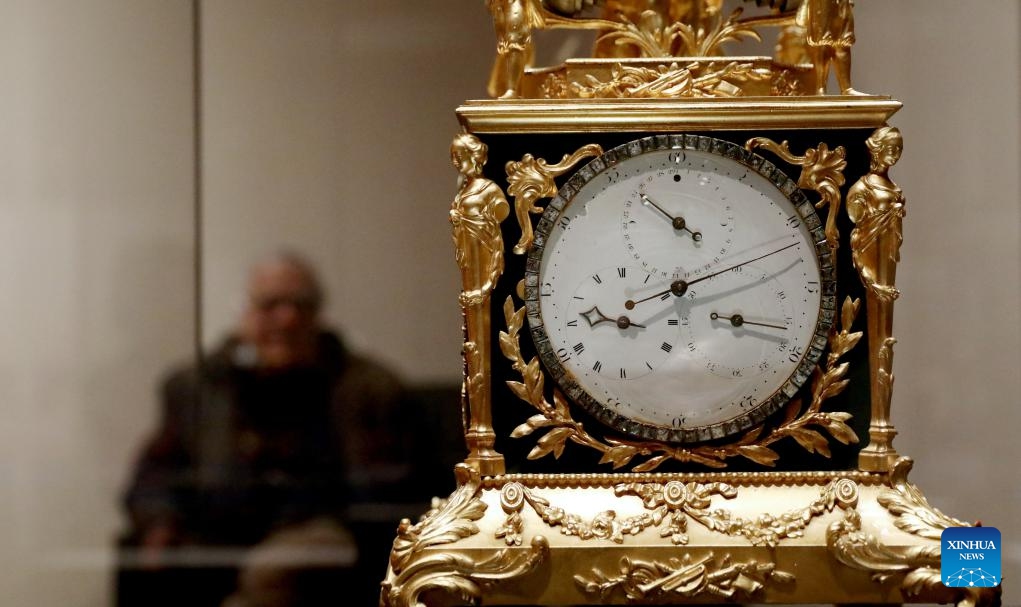 A man visits the exhibition Zimingzhong: Clockwork Treasures from China's Forbidden City, in London, Britain, Feb. 1, 2024. An exhibition opened at the Science Museum in London on Thursday, featuring 23 resplendent mechanical clocks, called zimingzhong, on loan from the Palace Museum in Beijing.(Photo: Xinhua)