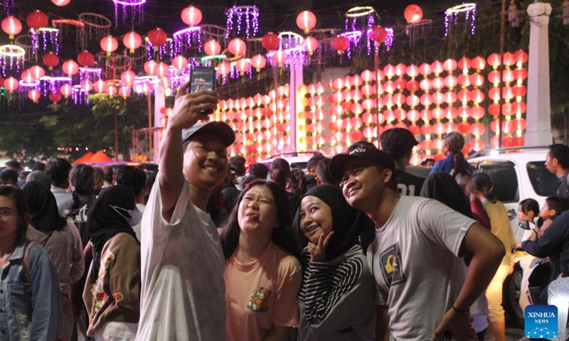 People take selfies as they enjoy light decorations during Chinese Lunar New Year celebration at Surakarta, Central Java, Indonesia, on Feb. 10, 2024. (Photo by Bram Selo/Xinhua)