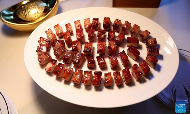 A Cantonese classic dish Roasted Char Siu is seen during a Chinese cuisine tasting event held at Mandarin Oriental Hyde Park Hotel in London, Britain, Feb. 2, 2024. During a Chinese cuisine tasting event held here on Friday, four master chefs from Shenzhen Culinary Association introduced the characteristics of Cantonese Cuisine, explained the cooking methods, and invited guests to prepare and taste the traditional Chinese Year's Eve dinner. (Xinhua/Li Ying)