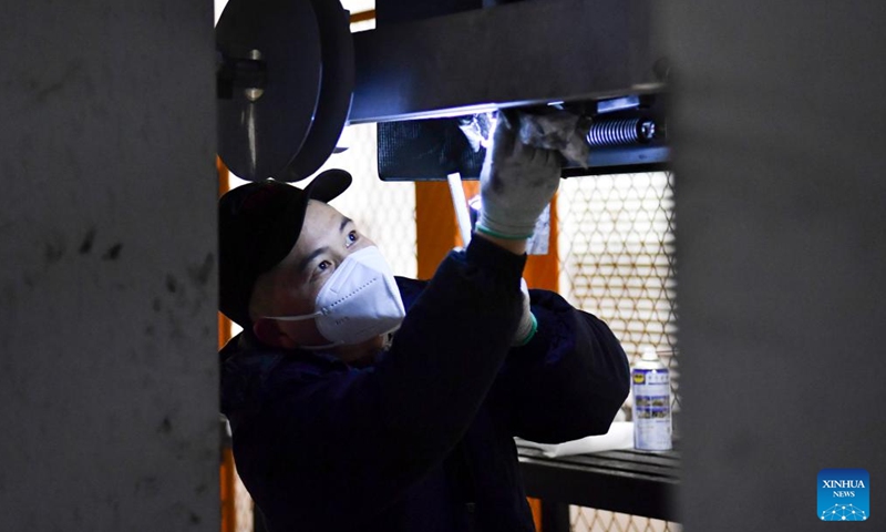 A worker checks a maglev train at the maintenance depot of Fenghuang maglev sightseeing express line at Fenghuang ancient town in Xiangxi Tujia and Miao Autonomous Prefecture, central China's Hunan Province, Feb. 2, 2024. 