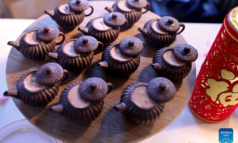 Teapot-shaped chocolate desserts are seen during a Chinese cuisine tasting event held at Mandarin Oriental Hyde Park Hotel in London, Britain, Feb. 2, 2024. During a Chinese cuisine tasting event held here on Friday, four master chefs from Shenzhen Culinary Association introduced the characteristics of Cantonese Cuisine, explained the cooking methods, and invited guests to prepare and taste the traditional Chinese Year's Eve dinner. (Xinhua/Li Ying)