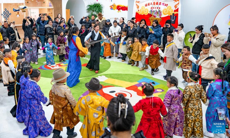 Children dance during a party at a bookstore in Lhasa, southwest China's Xizang Autonomous Region, Feb. 3, 2024.