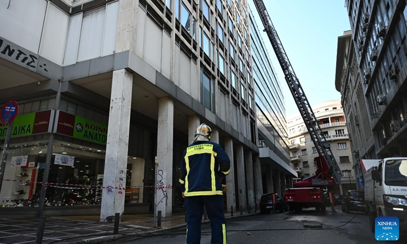 A firefighter is seen at the Ministry of Labor and Social Affairs after a bomb exploded opposite the ministry building in Athens, Greece, Feb. 3, 2024. A bomb exploded opposite the Ministry of Labor and Social Affairs in central Athens on Saturday, causing extensive material damage, but no injuries, Greek national broadcaster ERT reported. (Xinhua/Marios Lolos)