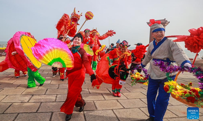 Folk artists perform on the day of Lichun, meaning the beginning of spring, the first solar term in the traditional Chinese lunar calendar, in Rongcheng, east China's Shandong Province, Feb. 4, 2024. (Photo by Li Xinjun/Xinhua)