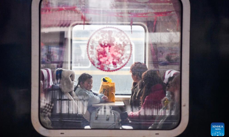 This photo taken on Feb. 4, 2024 shows passengers aboard the train No. 7503 in northwest China's Gansu Province. The pair of slow trains No. 7503 and No. 7504 run between Tianshui and Longxi in Gansu. Local residents are now taking them to travel between their towns and the urban areas to shop for goods in preparation of the upcoming Chinese Lunar New Year, or the Spring Festival.(Photo: Xinhua)