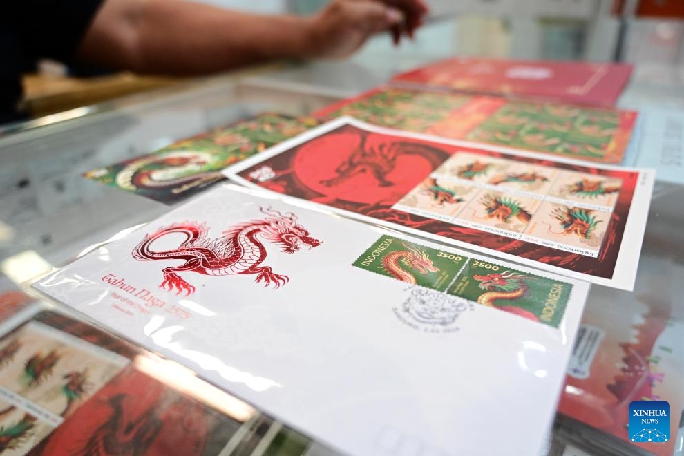 Series of postage stamps in celebration of the upcoming Chinese Lunar New Year, or the Year of the Dragon, are seen at a PT Pos Indonesia office in Jakarta, Indonesia, Feb. 6, 2024. The stamps were issued by Indonesian state-owned postal service company PT Pos Indonesia and the country's Ministry of Communications and Informatics on Friday.(Photo: Xinhua)