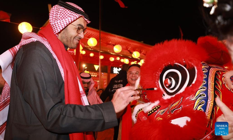 A guest dots the eyes of a dancing lion during an event celebrating the upcoming Chinese Lunar New Year, or the Spring Festival, at the Chinatown of the Boulevard World in Riyadh, Saudi Arabia, on Feb. 5, 2024.(Photo: Xinhua)