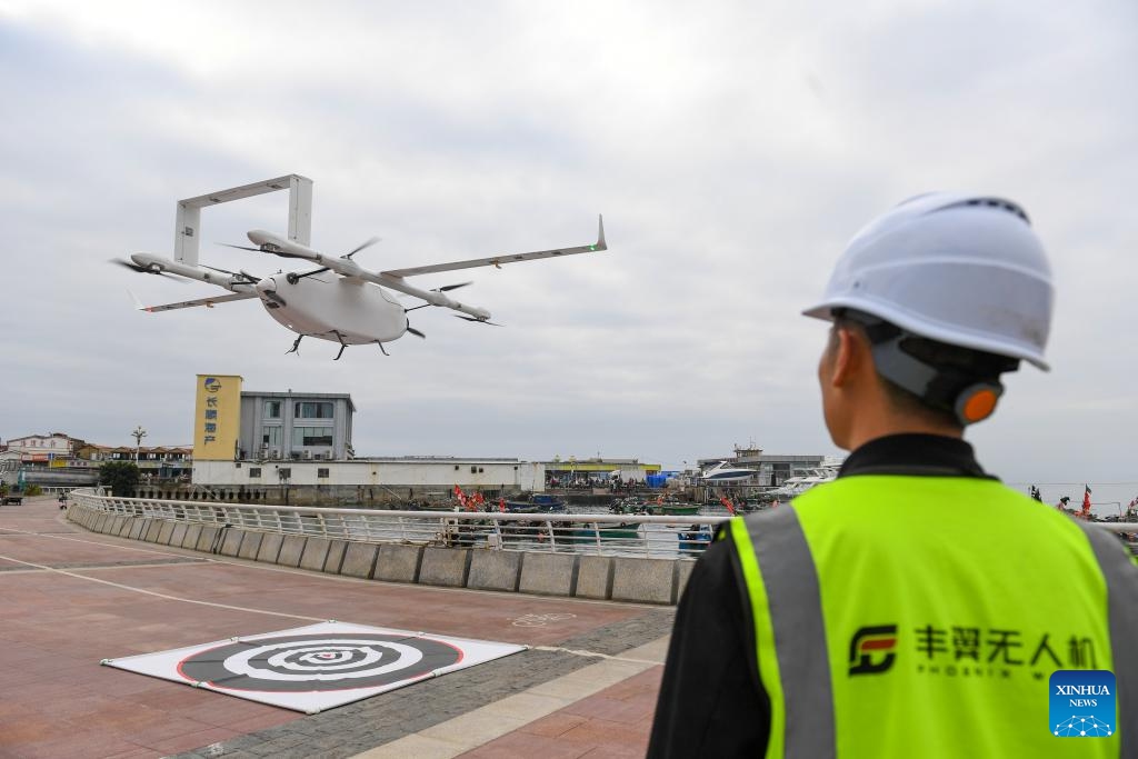 A drone carrying seafood takes off from Nan'ao Shuangyong Pier in Shenzhen, south China's Guangdong Province, Feb. 5, 2024. A drone delivery route for seafood has been put into operation between Nan'ao Shuangyong Pier in the east of Shenzhen and the city's Longgang District. The drones take off with up to 20 kilograms load and the seafood will be delivered to local couriers and finally reach the customers.(Photo: Xinhua)