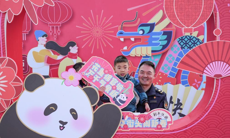 Passengers pose for photos with a Spring Festival decorative installation at Chengdu East Railway Station in Chengdu, southwest China's Sichuan Province, Feb. 9, 2024. People across the country held various celebrations on Friday, the Chinese Lunar New Year's eve, to welcome the traditional festival. Photo: Xinhua