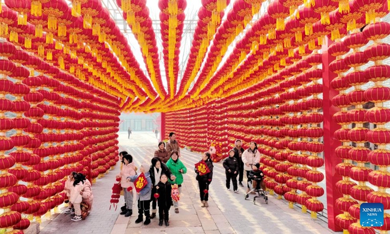 Tourists visit a lantern-decorated corridor in Deqing County of Huzhou City, east China's Zhejiang Province, Feb. 9, 2024. People across the country held various celebrations on Friday, the Chinese Lunar New Year's eve, to welcome the traditional festival. Photo: Xinhua