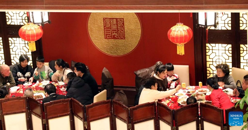 People have family reunion dinners at a restaurant in Suzhou, east China's Jiangsu Province, Feb. 9, 2024. People across the country enjoy the festive atmosphere with family reunion dinners on the eve of Chinese Lunar New Year on Friday. Photo: Xinhua