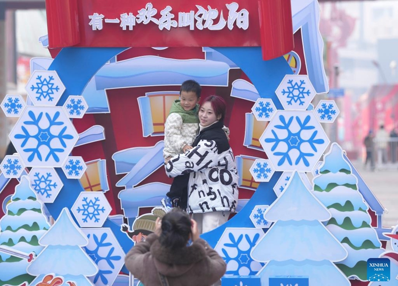 Tourists pose for photos in Shenyang, northeast China's Liaoning Province, Feb. 9, 2024. People across the country held various celebrations on Friday, the Chinese Lunar New Year's eve, to welcome the traditional festival. Photo: Xinhua