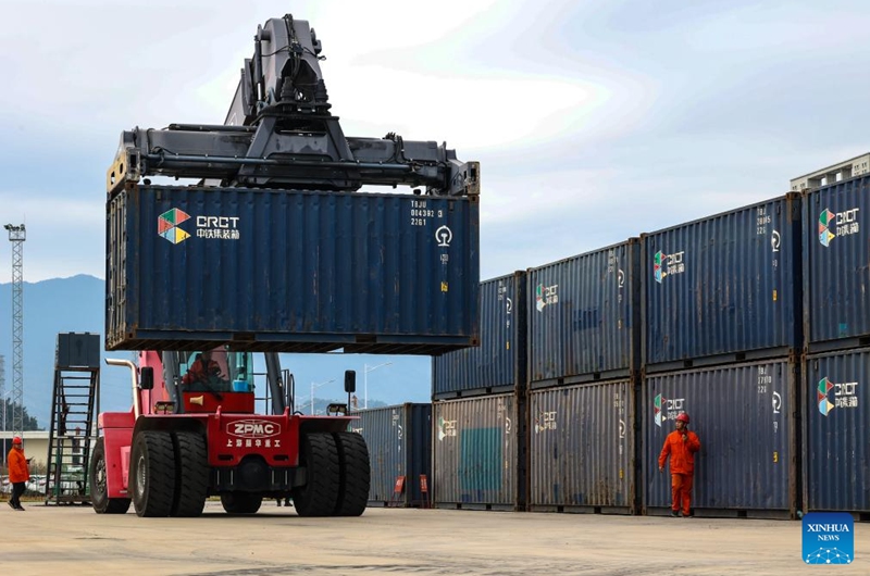 A forklift loads cargo containers at the Ningde land port in Ningde, southeast China's Fujian Province, Feb. 8, 2024. The Ningde land port, with vehicle transportation railway lines and vehicle loading and unloading platforms, has served as a logistics distribution center and shipment hub for vehicles to be exported to global markets. Photo: Xinhua