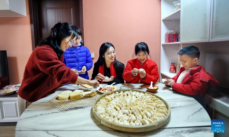 People make dumplings for a family reunion dinner in Heshan, south China's Guangdong Province, Feb. 9, 2024. People across the country enjoy the festive atmosphere with family reunion dinners on the eve of Chinese Lunar New Year on Friday. Photo: Xinhua