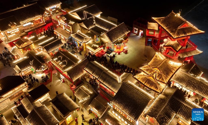 An aerial drone photo shows people visiting an old block decorated with lighting in Tangshan, north China's Hebei Province, Feb. 10, 2024.Lighting and appreciating lanterns during the Spring Festival is a time-honored tradition in China. (Xinhua/Yang Shiyao)