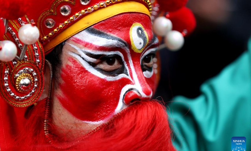 An artist performs Yingge Dance, a form of folk dance popular in south China's Guangdong Province, at Burlington Arcade in London, Britain, Feb. 10, 2024. (Xinhua/Li Ying)