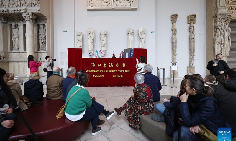 People watch a puppet show staged by Zhangzhou Puppet Troupe from southeast China's Fujian Province at the City of Architecture and Heritage Museum in Paris, France, Feb. 10, 2024. (Xinhua/Gao Jing)