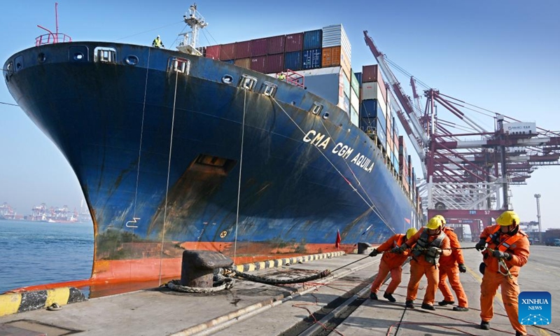 Staff members work at Qingdao Port, east China's Shandong Province, Feb. 11, 2024. The Qingdao port is busy handling goods for export during the Spring Festival holiday. (Xinhua/Li Ziheng)