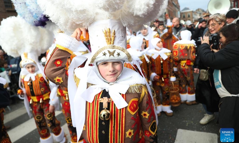 Local residents wearing costumes of Gille attend the parade of Shrove Tuesday, the last day of Carnival, in Binche, Belgium, Feb. 13, 2024. Binche's three-day carnival, a UNESCO World Heritage event and one of the most famous carnivals in Europe, reached its climax on Tuesday. (Photo: Xinhua)