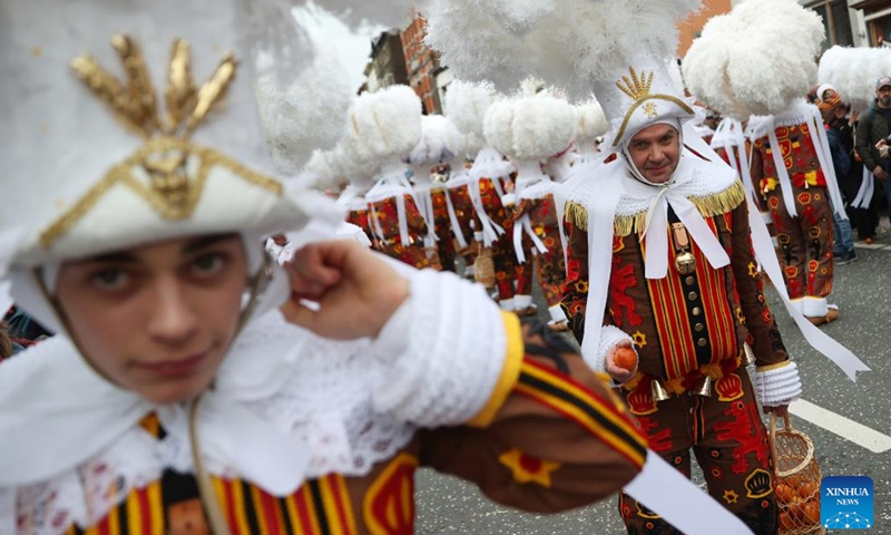 Local residents wearing costumes of Gille attend the parade of Shrove Tuesday, the last day of Carnival, in Binche, Belgium, Feb. 13, 2024. Binche's three-day carnival, a UNESCO World Heritage event and one of the most famous carnivals in Europe, reached its climax on Tuesday. (Photo: Xinhua)