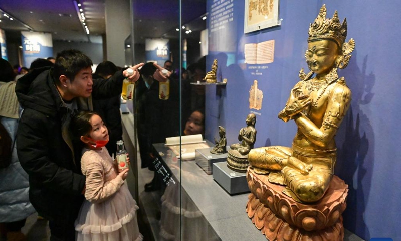 Visitors view exhibits at a museum in Urumqi, capital of northwest China's Xinjiang Uygur Autonomous Region, Feb. 14, 2024. Many people choose to spend their Spring Festival holiday by viewing exhibitions in museums. (Photo: Xinhua)