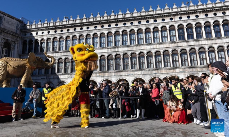 People watch a lion dance performance at Piazza San Marco in Venice, Italy, Feb. 13, 2024. A Chinese costume show was held on Tuesday as a major event of the carnival season. (Photo: Xinhua)