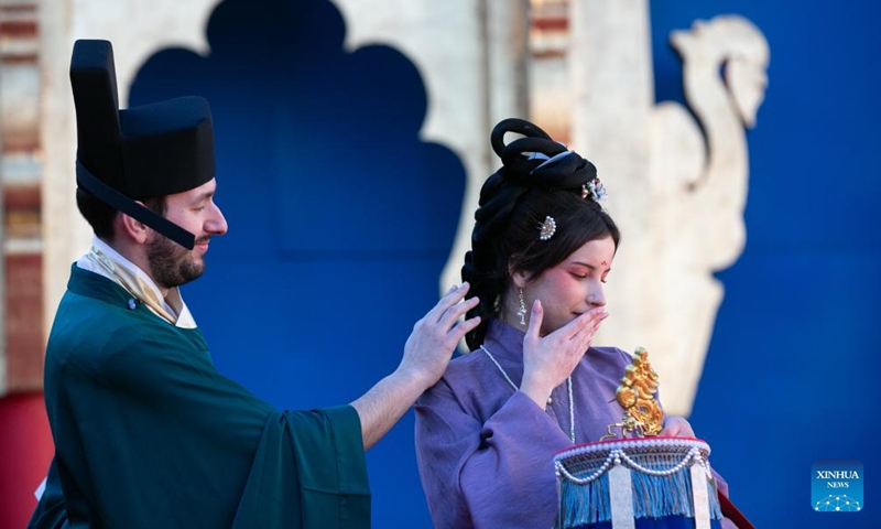 Italian volunteers display Hanfu, a style of clothing traditionally worn by the Han people, at Piazza San Marco in Venice, Italy, Feb. 13, 2024. A Chinese costume show was held on Tuesday as a major event of the carnival season. (Photo: Xinhua)