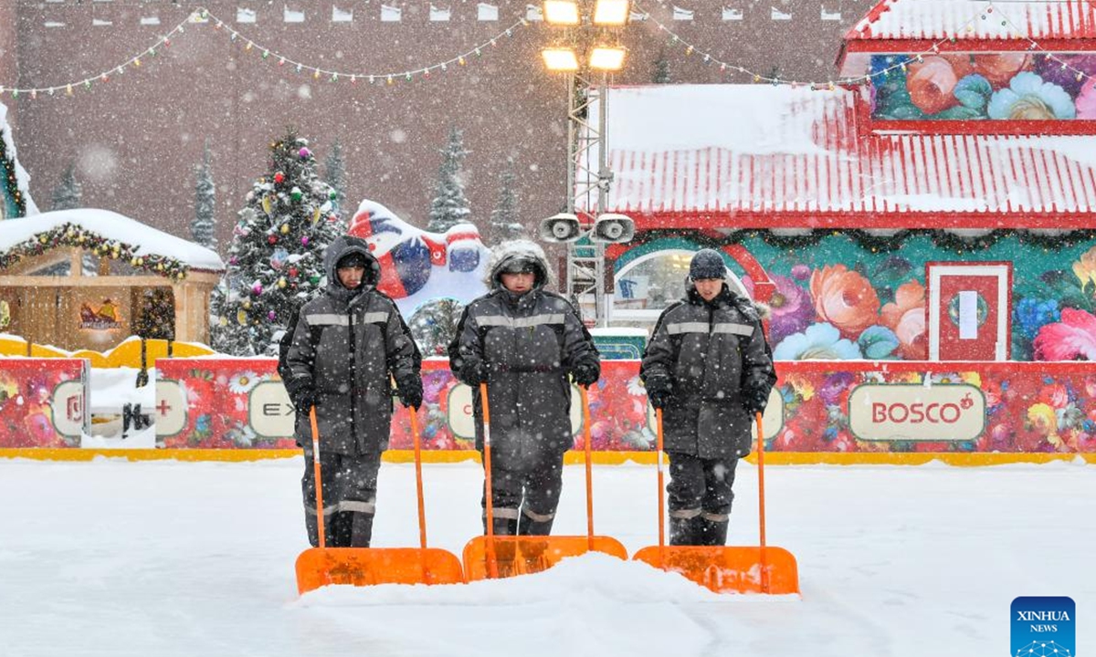 Workers clear snow off an ice rink in Moscow, Russia, Feb. 15, 2024. A heavy snow hit Moscow on Thursday. (Xinhua/Cao Yang)