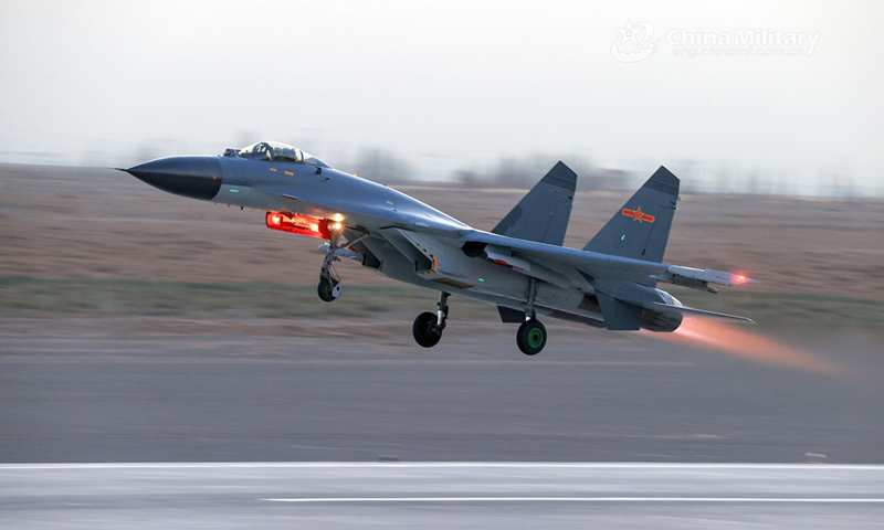 A fighter jet attached to a brigade of the PLA Air Force Xi'an Flying College takes off during a 24-hour flight training exercise. (eng.chinamil.com.cn/Photo by Cui Baoliang)