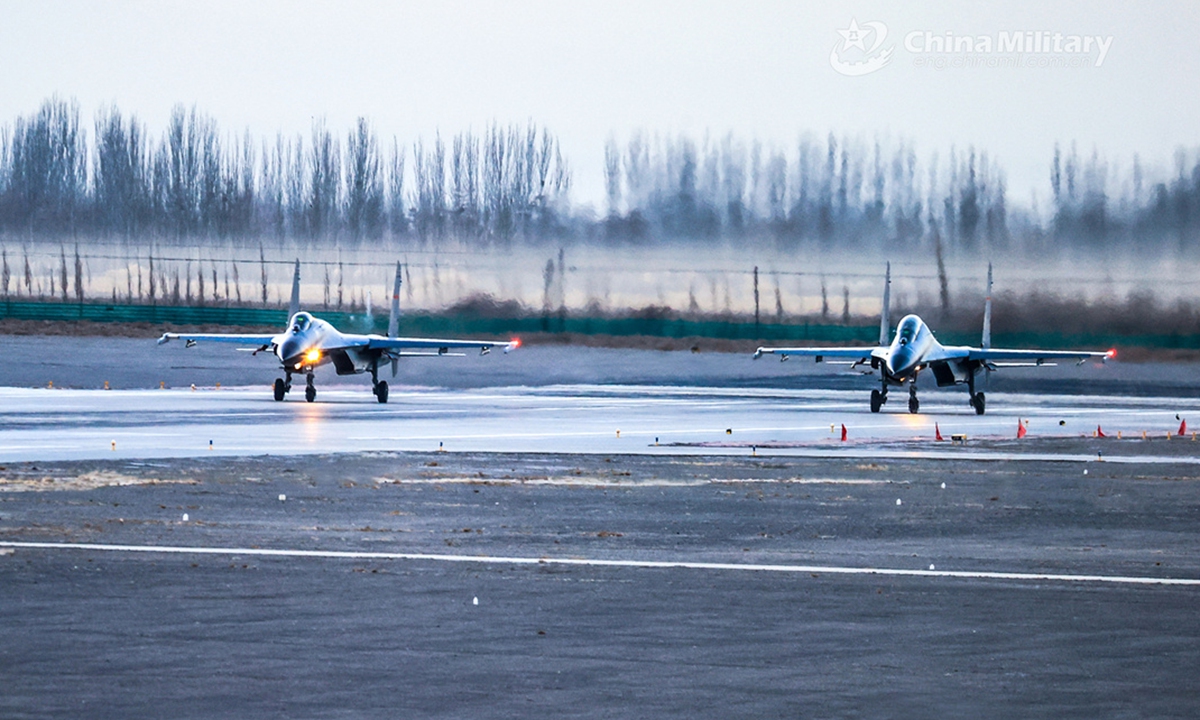 Two fighter jets attached to a brigade of the PLA Air Force Xi'an Flying College taxi on the runway before takeoff during a 24-hour flight training exercise. (eng.chinamil.com.cn/Photo by Cui Baoliang)