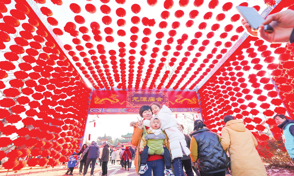 A family visits the Longtan temple fair on February 10, 2024 in Beijing. Photo: VCG
