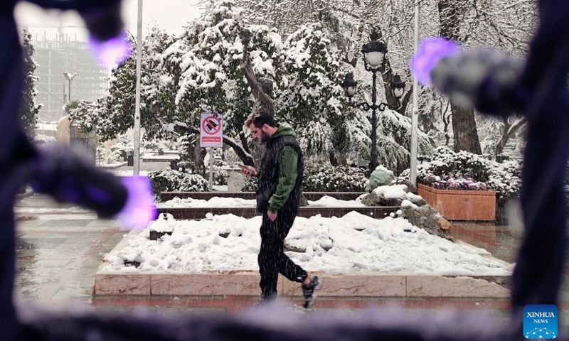 A man walks on the street amid snow in Tehran, Iran, Feb. 25, 2024. (Xinhua/Shadati)